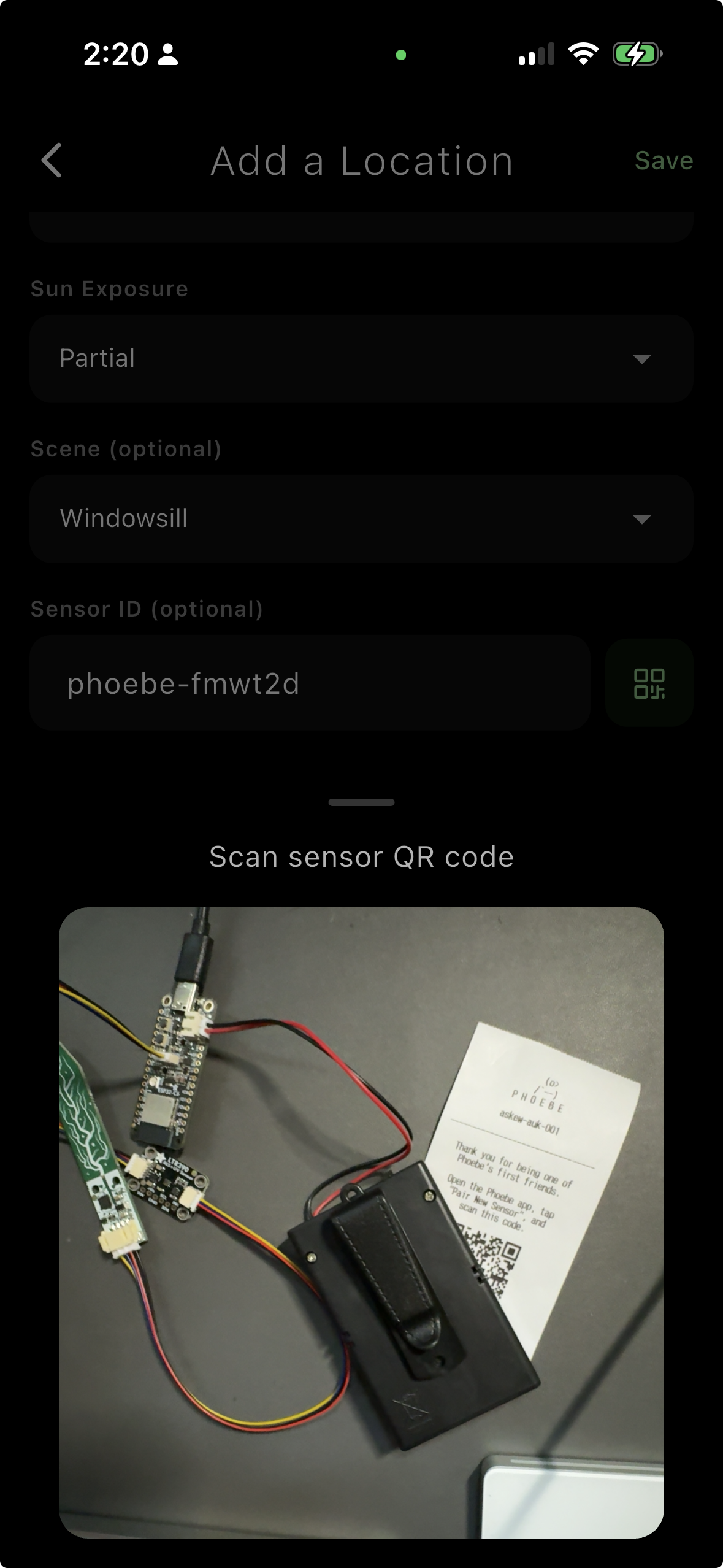 Phoebe app scanning a QR code on a thermal-printed receipt, with the Askew Auk prototype board visible on the desk