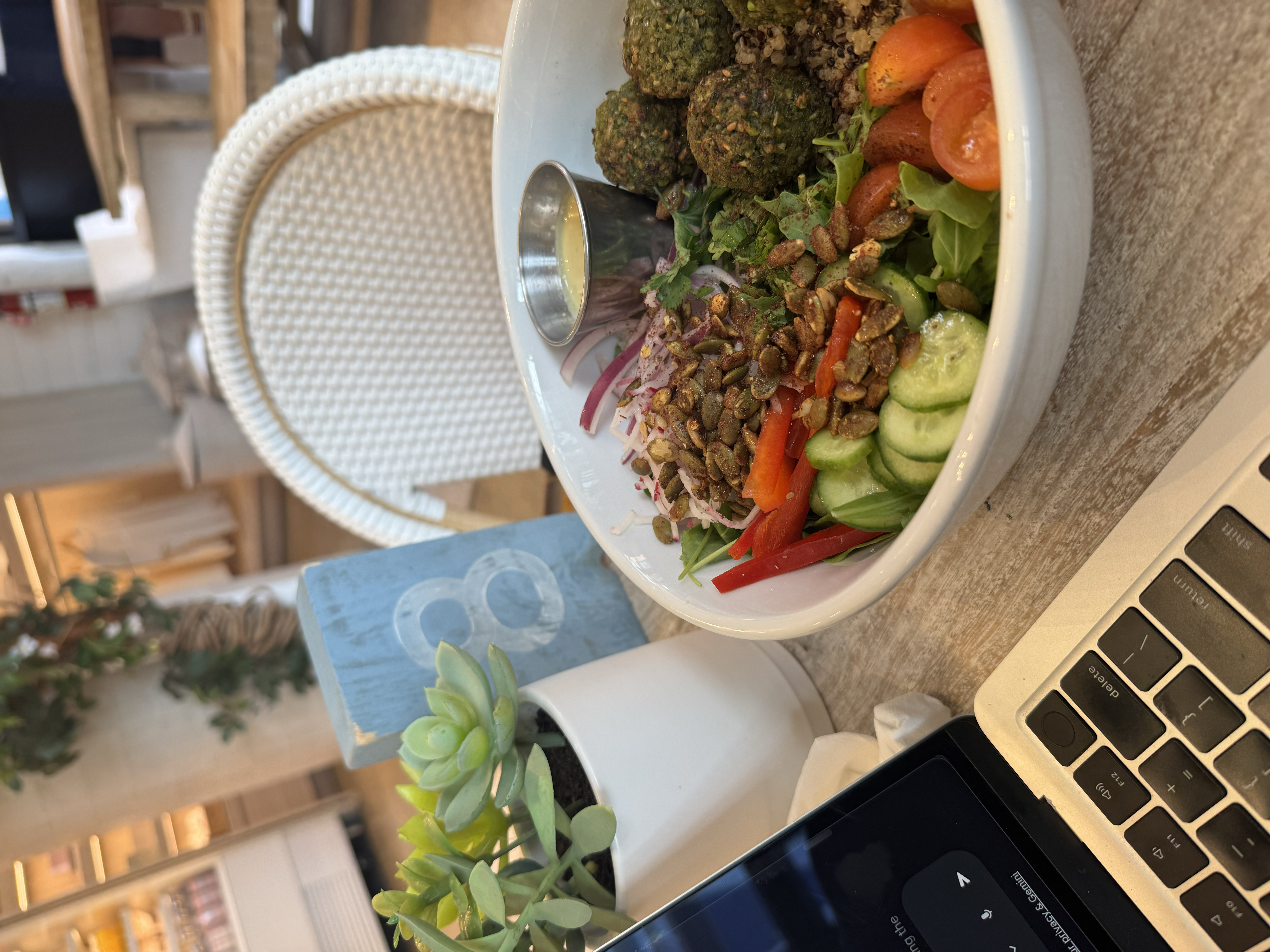 Laptop showing KiCad next to a health bowl and a succulent in a trendy Williamsburg restaurant
