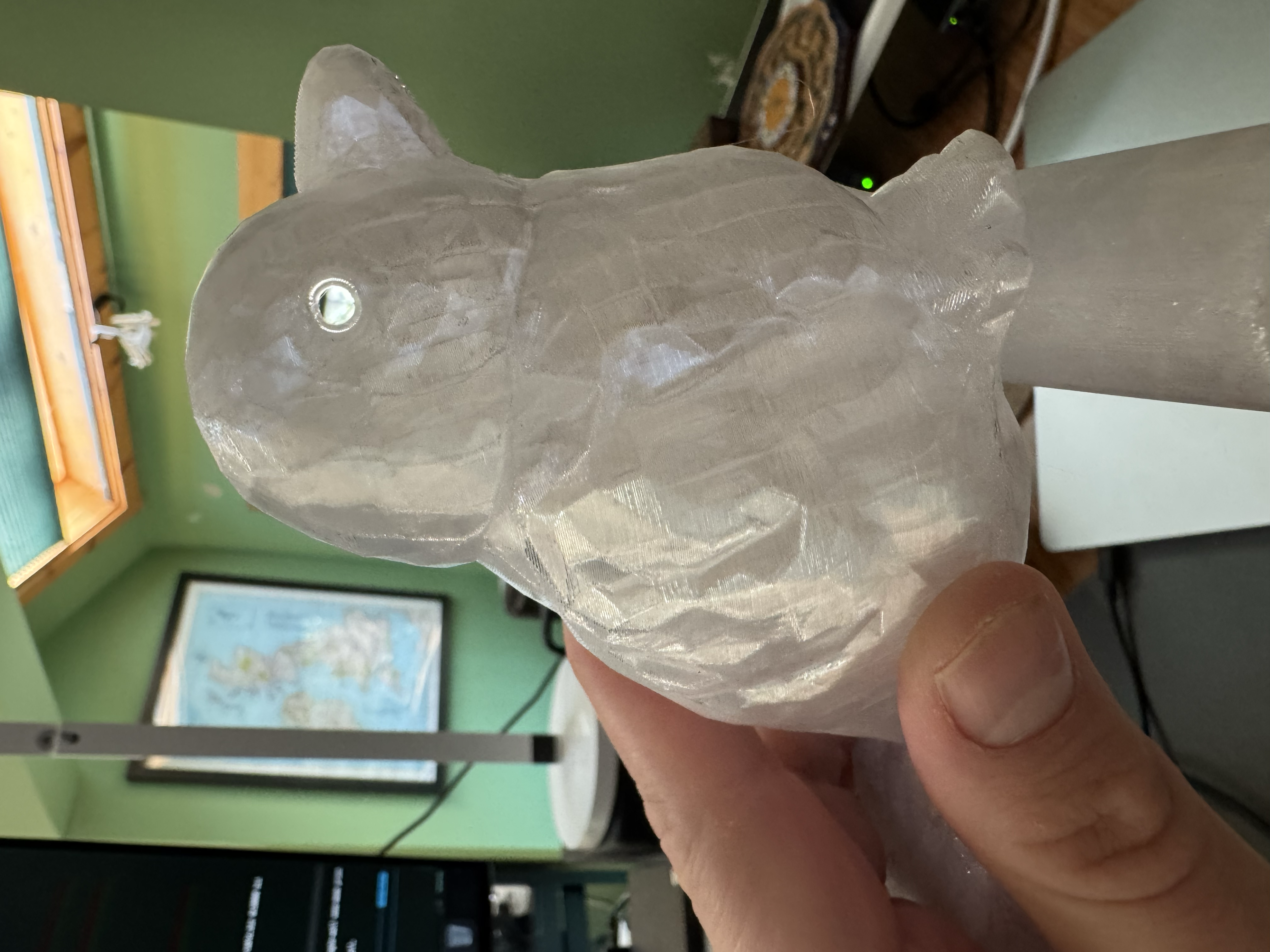Translucent PETG Phoebe bird held in hand, showing eyes and Perch tube